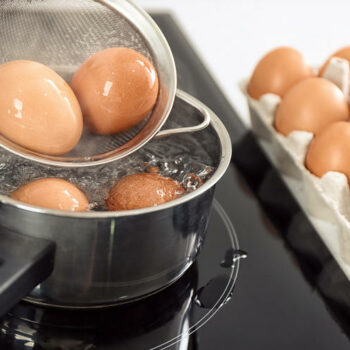 Eggs boiling in pan, closeup