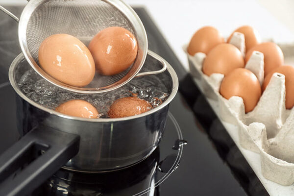Eggs boiling in pan, closeup